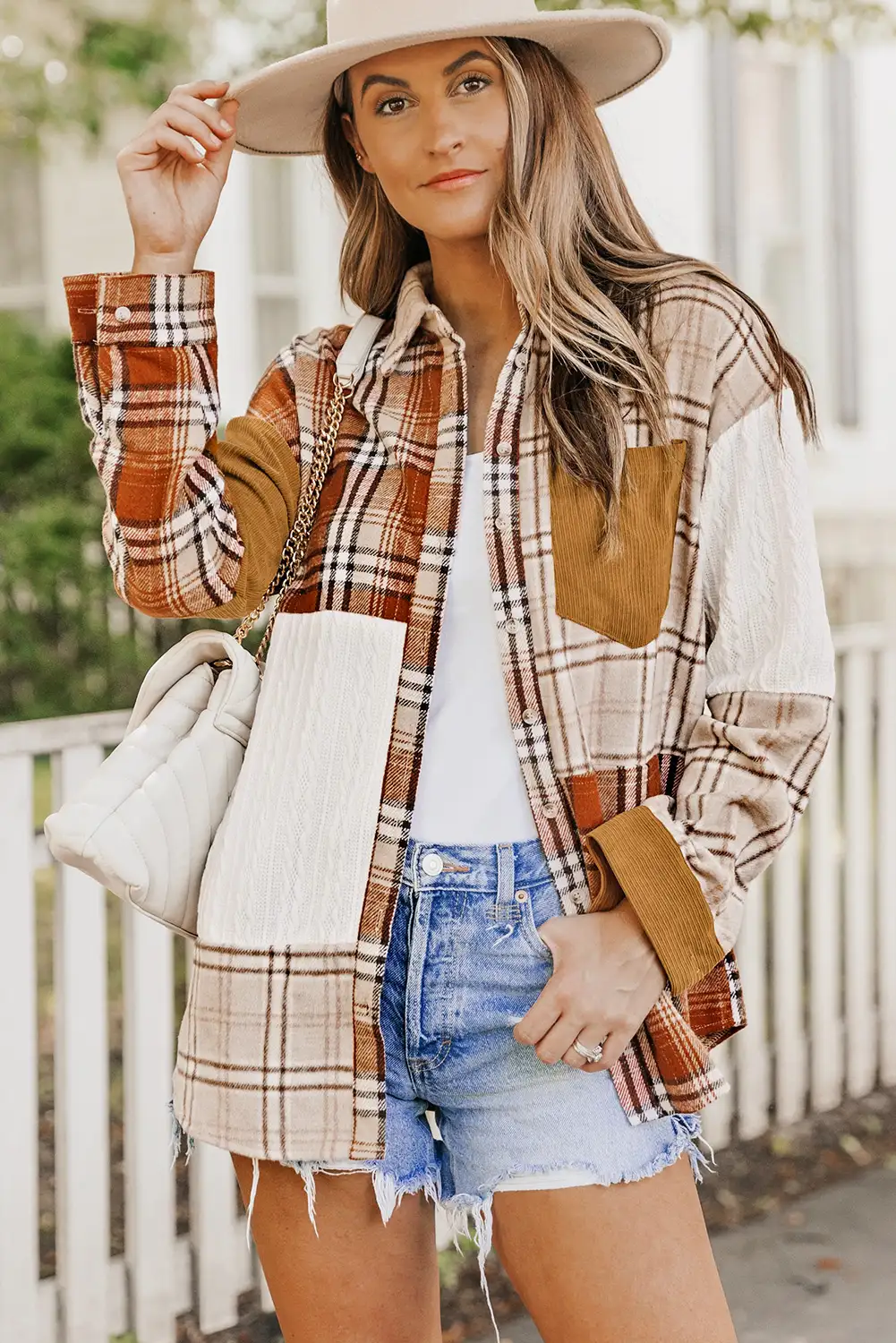 Woman wearing an orange color block jacket in soft natural light