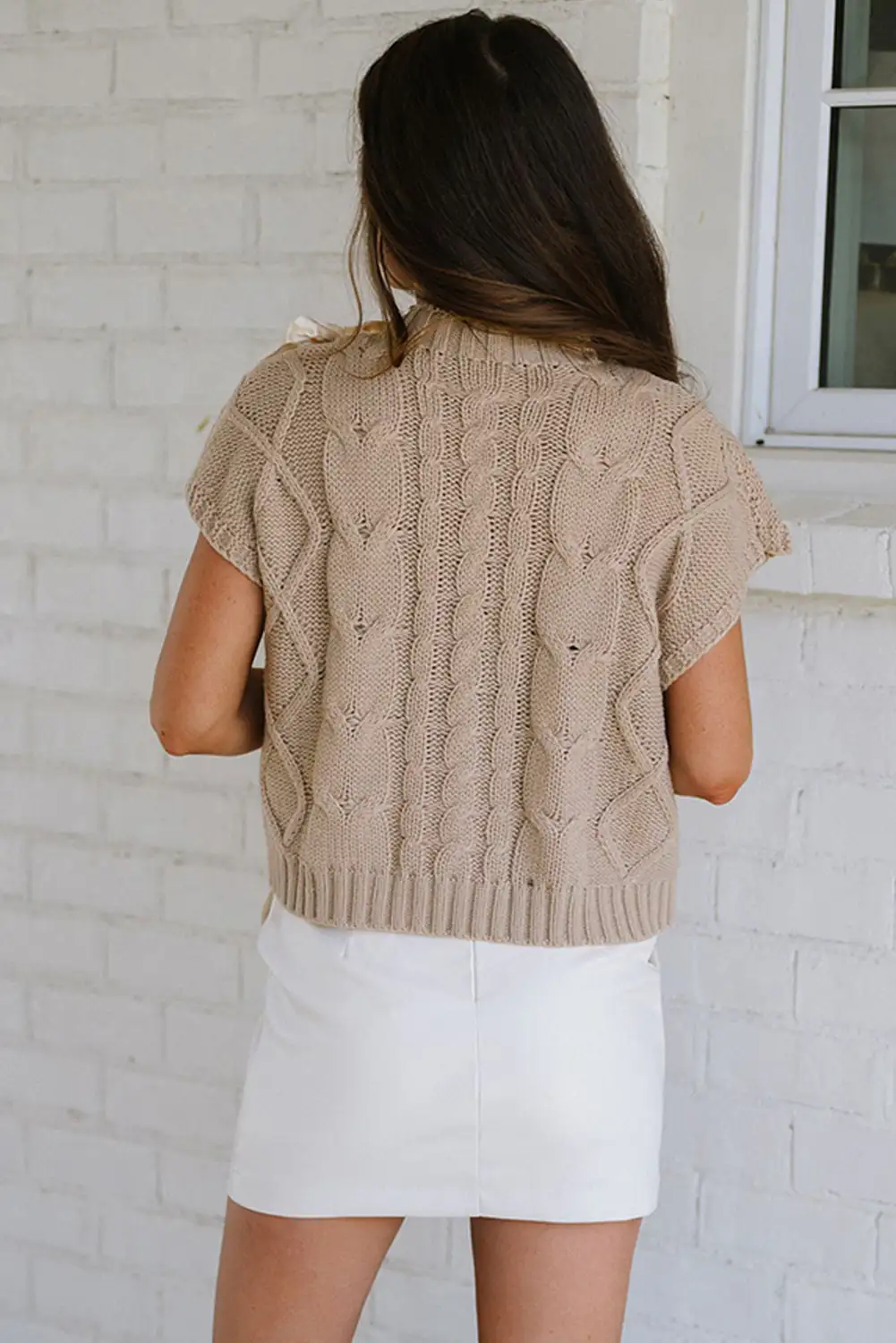 Detail view of the satin bowknot colorblock sweater